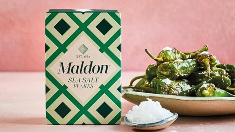Maldon sea salt box next to padron peppers.