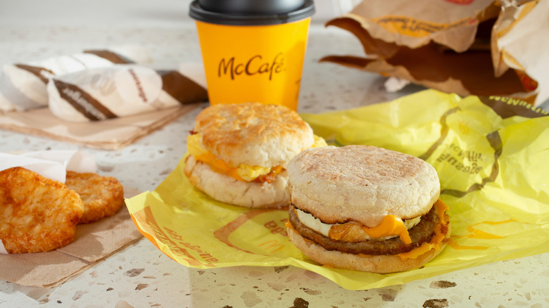 McDonald's breakfast with breakfast sandwiches and a McCafe coffee.