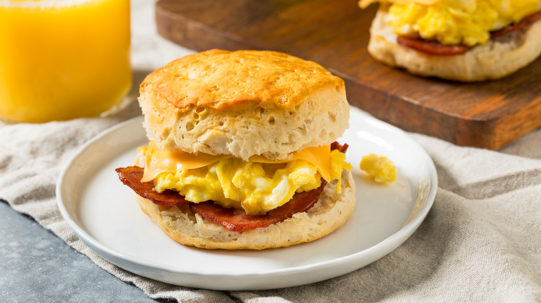 A breakfast sandwich on a white plate.