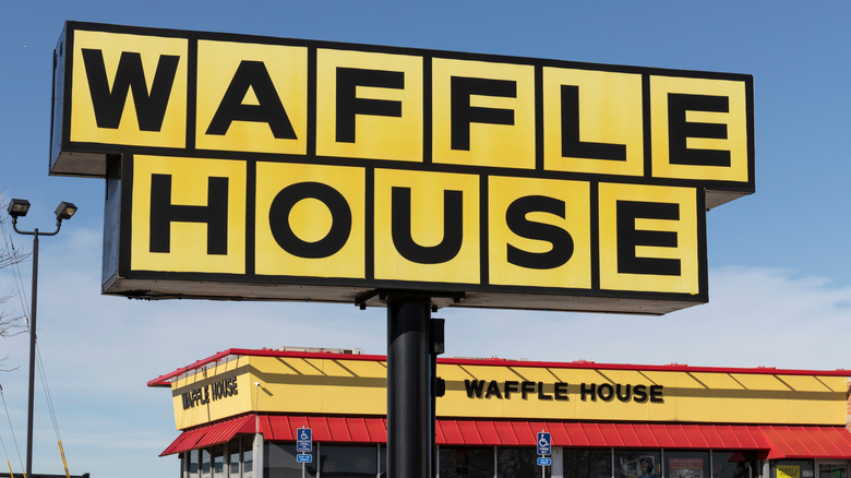 Large sign for Waffle House outside a Waffle House restaurant.