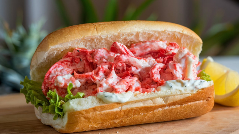 A lobster roll on a wooden board