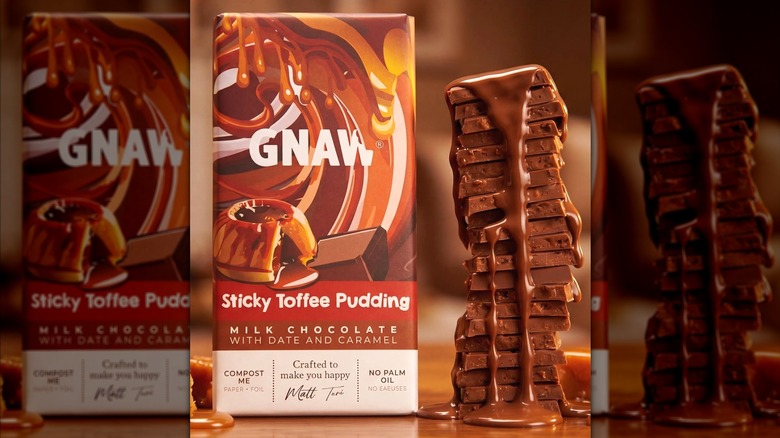 A Gnaw Sticky Toffee Pudding bar and a stack of chocolate pieces.