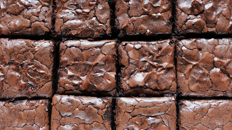 bBrowies cut up in a pan are shown close up.