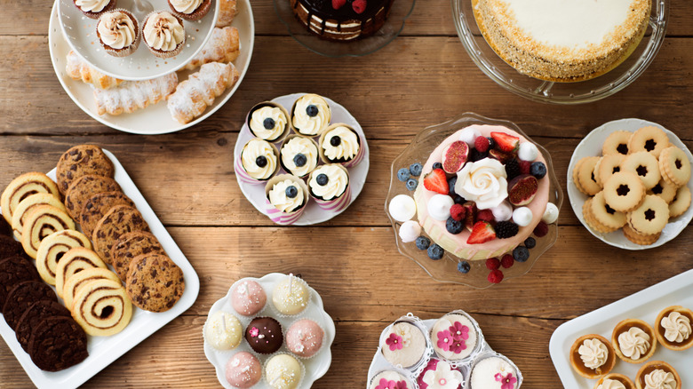 Various cookies, cakes, and desserts are set up on a table.