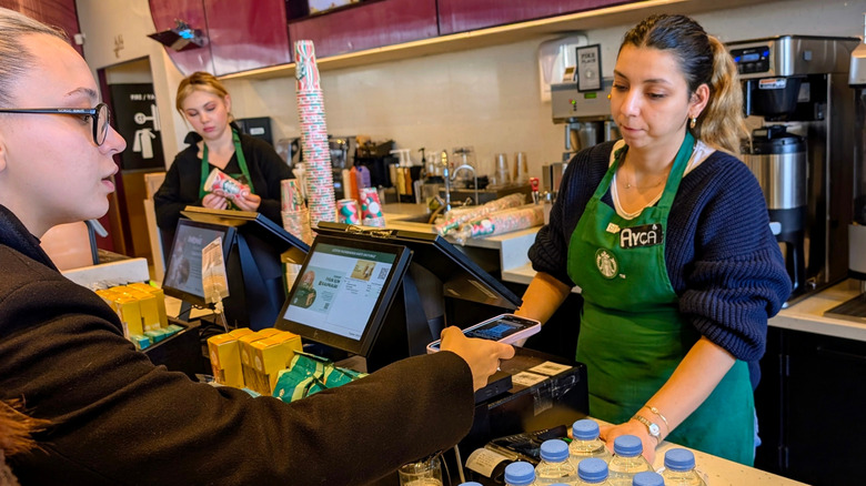 Starbucks customer pays for order at register