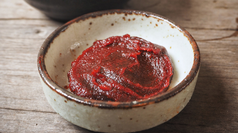 Bowl of gochujang on wooden table
