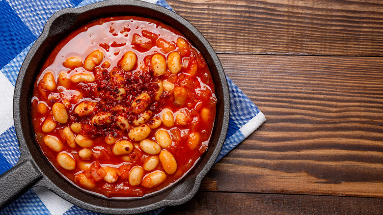 Pot of baked beans in a cast iron skillet