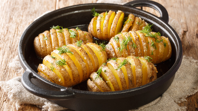 Hasselback potatoes in black pan