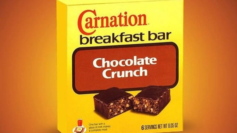 Box of Chocolate Breakfast Bars in Chocolate Crunch flavor, over orange background