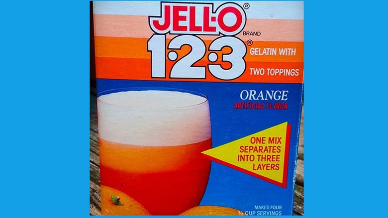 Box of Jell-) 1-2-3 Orange flavor over blue background