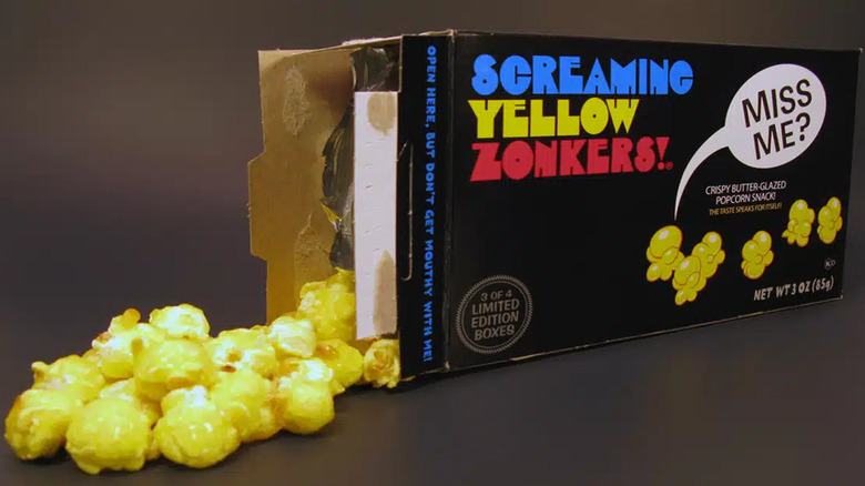 Open box of Screaming Yellow Zonkers on its side with some popcorn spilled out