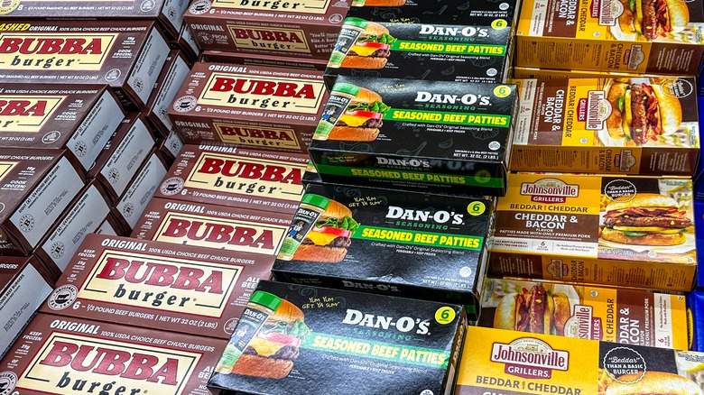 Collection of frozen store-bought burger patties in store cooler