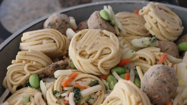 Frozen Asian pasta mix in frying pan