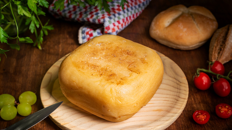 Mahón cheese pictured with grapes.