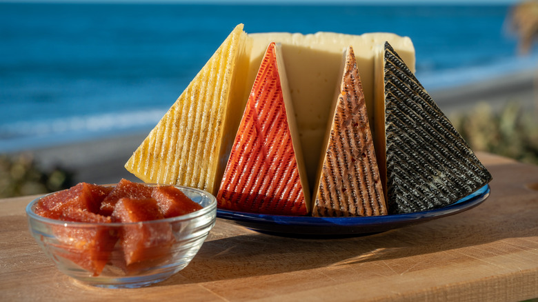 A variety of Manchego cheeses served with quince paste