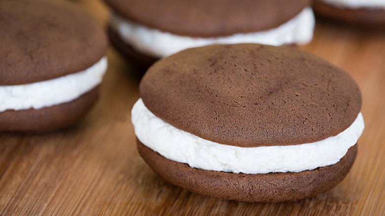 close up of a chocolate whoopie pie cookie sandwich with white cream filling