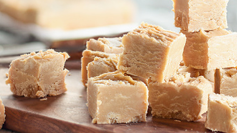 several smalle pieces of homemade peanut butter fudge stacked on top of each other