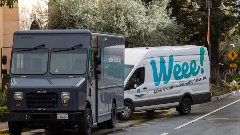 Amazon and Weee! delivery vehicles parked on a street