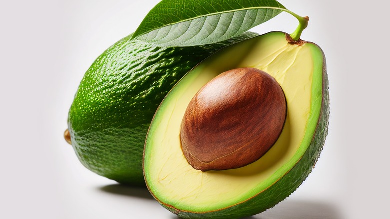 Whole avocado with leaf
