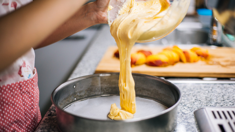 pouring cake batter into pan
