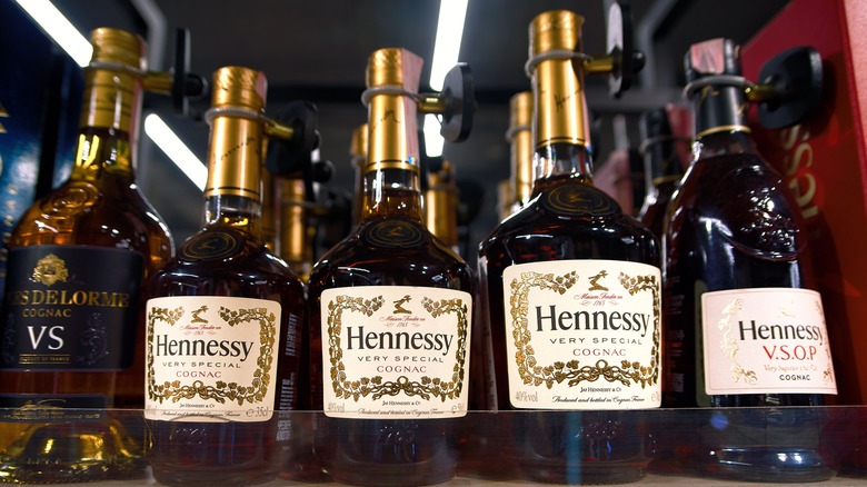Shelf full of Hennessy cognac bottles