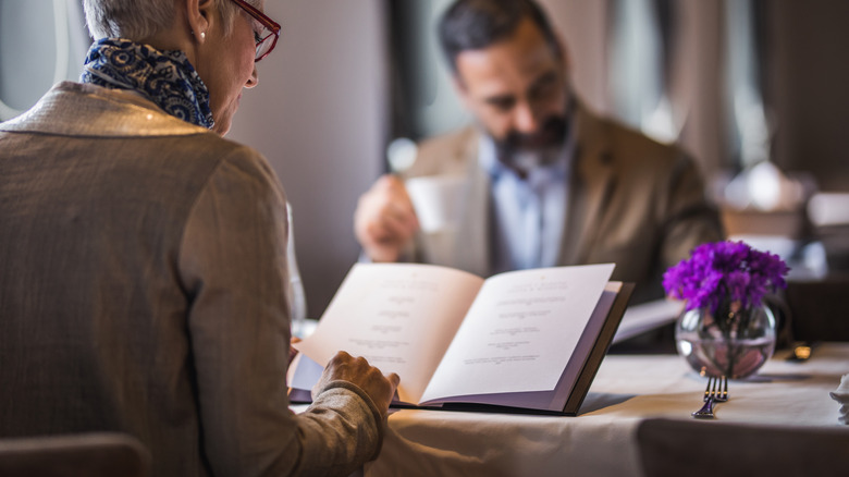 couple reviewing menus at a restaurant