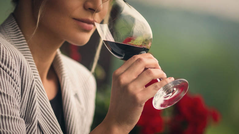 woman sniffing a glass of red wine