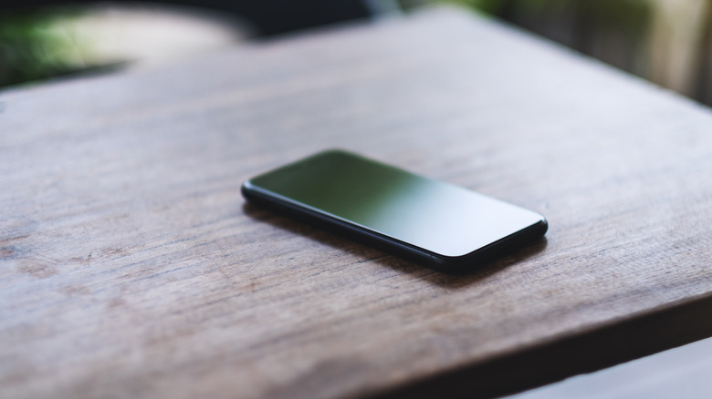 cell phone on a wooden table