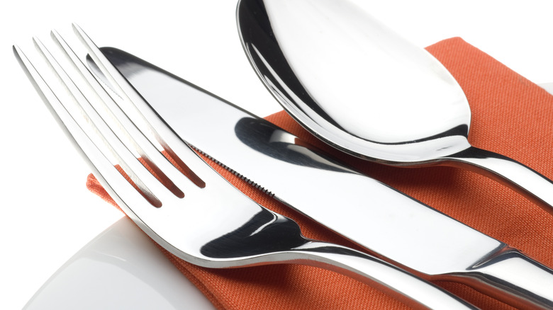 closeup of silverware on top of napkin