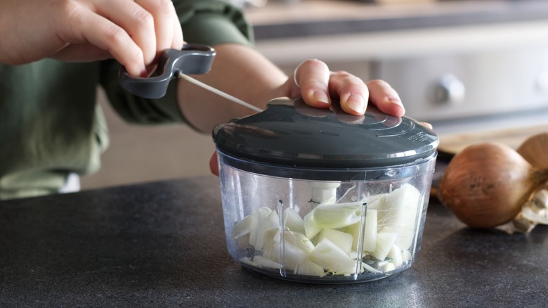 cutting onions in onion chopper