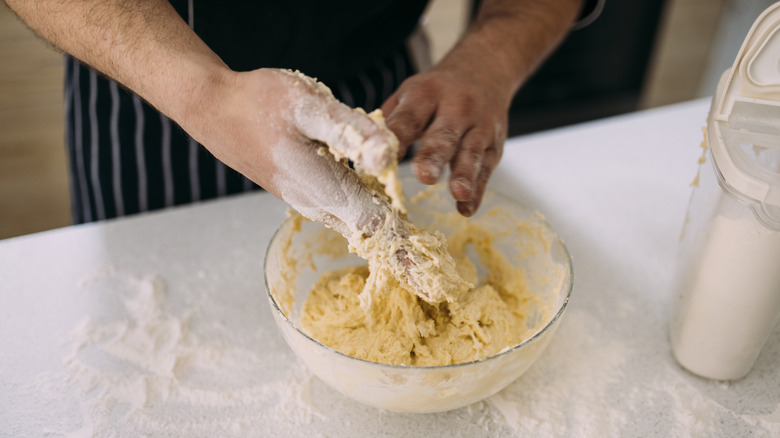 Cook's hands kneading dough