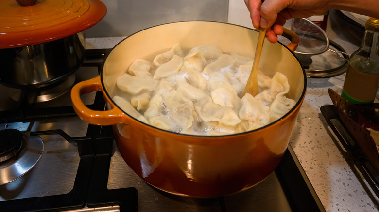 Stirring dumplings in boiling water