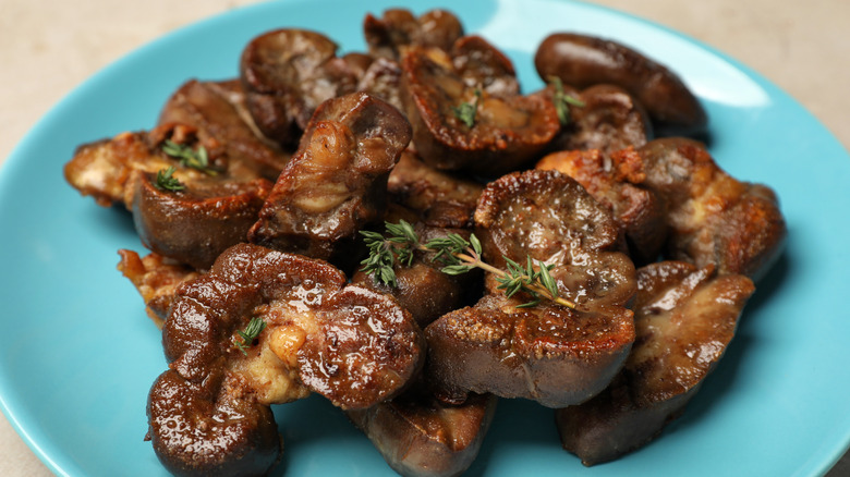 Platter of pan-fried lamb kidneys on turquoise plate