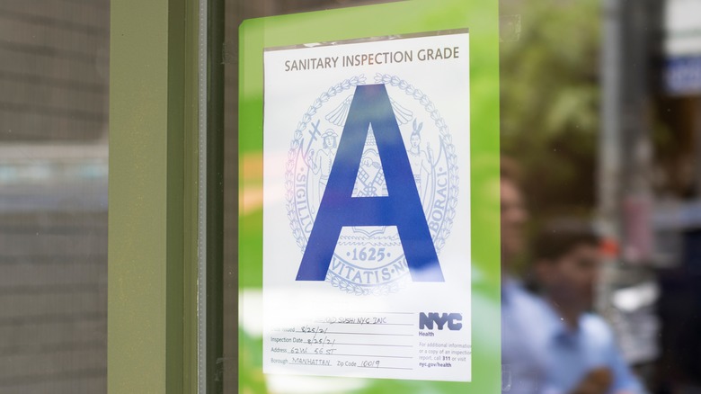 An inspection grade in the window of a restuarant
