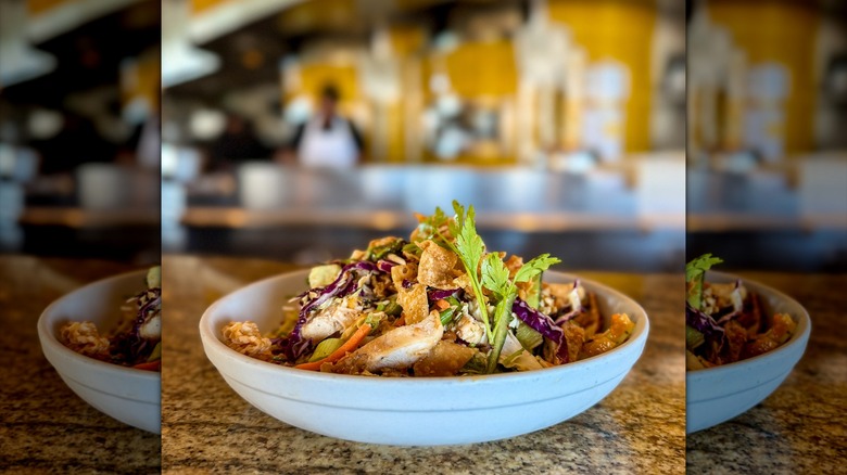 The Thai Crunch Salad from California Pizza Kitchen on a countertop