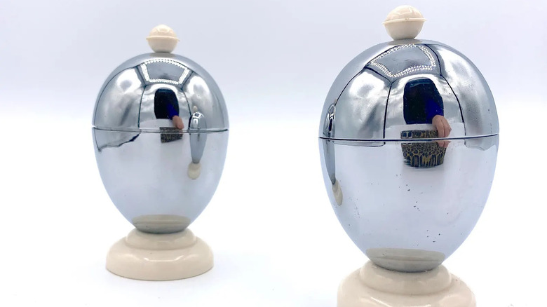 A pair of chrome egg cup warmers.