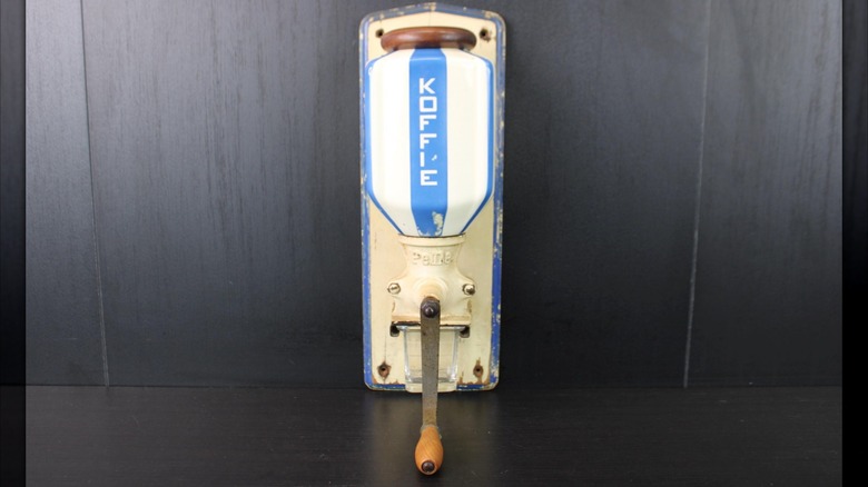 An art deco wall mounted coffee grinder.