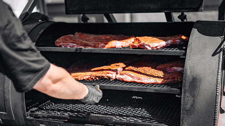Pork going into a smoker