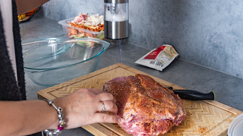 Seasoning raw pork shoulder