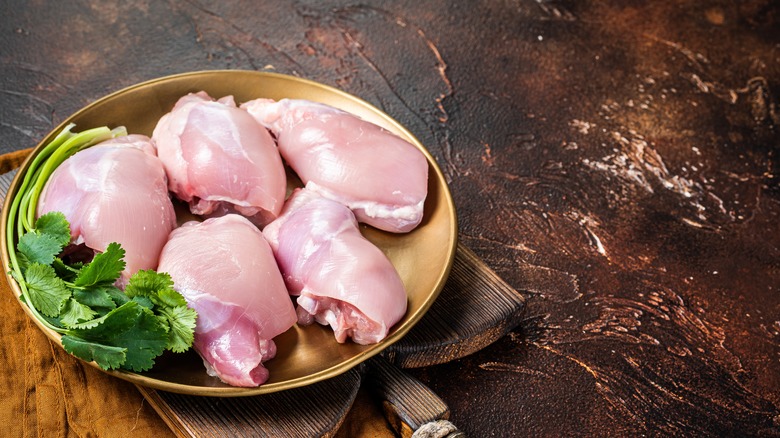 Chicken thighs in bowl