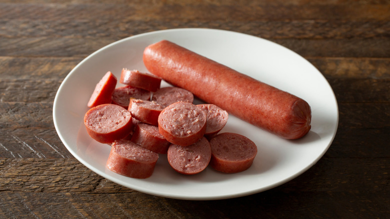 Whole hot dog next to hot dog slices
