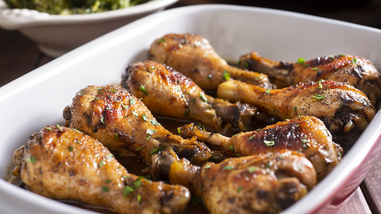 Chicken legs in baking dish covered in dark glaze