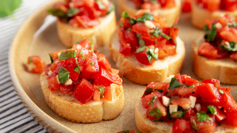 Platter of bruschetta topped crostinis