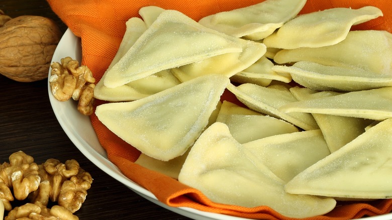 fresh pansotti on plate with walnuts