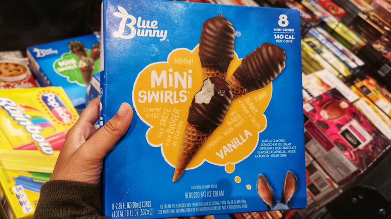 Hand holding a box of Blue Bunny Chocolate-Dipped Vanilla Mini Swirls Ice Cream Cones