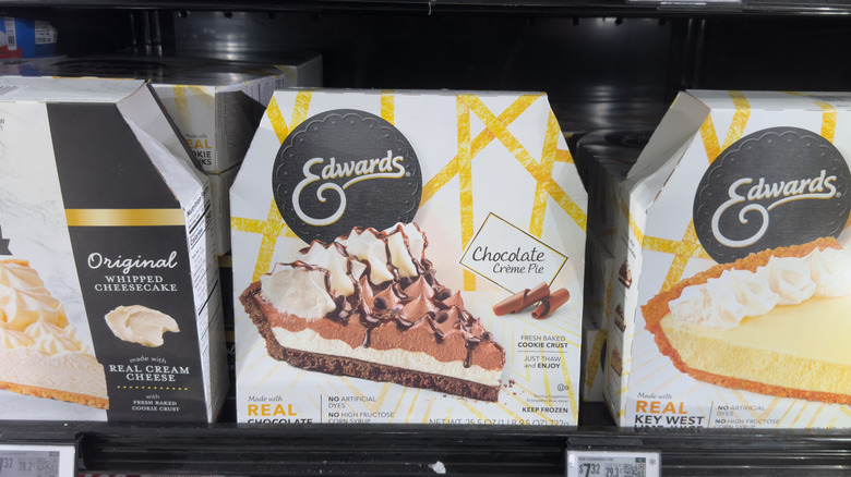 Various flavors of Edwards frozen pies in a store freezer