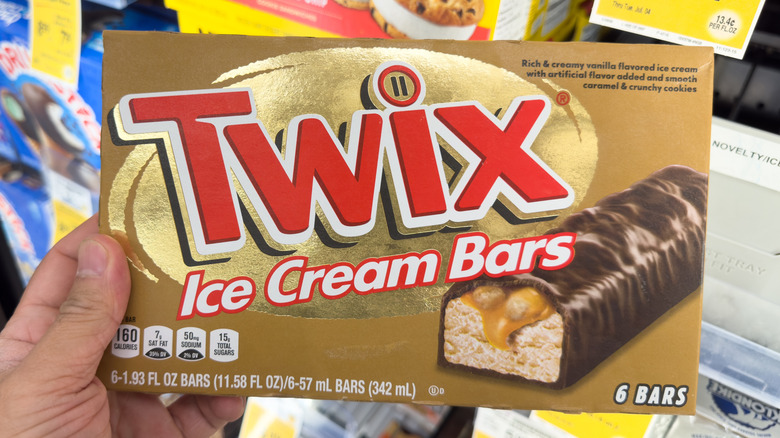 Hand holding a box of Twix Ice Cream Bars