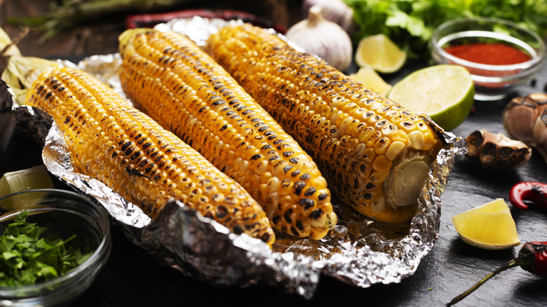 Grilled corn in aluminum foil.