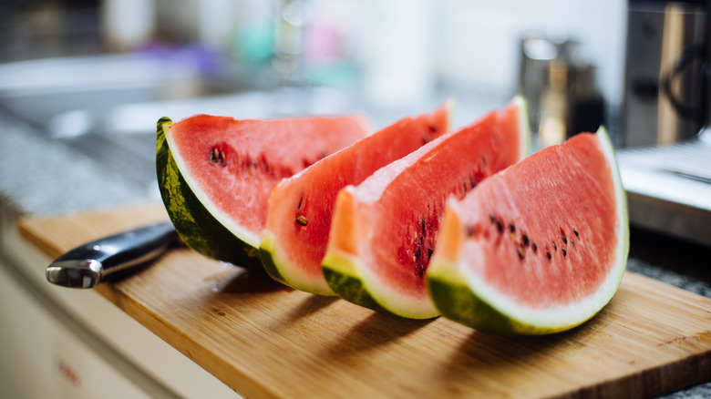 slices of watermelon with rind on cutting board