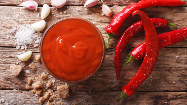 bowl of Sriracha surrounded by its ingredients